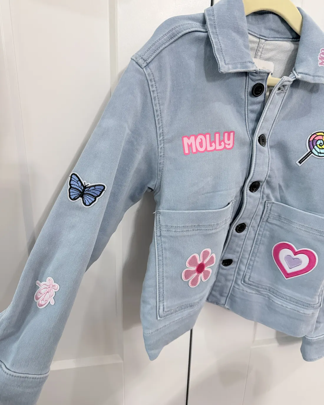 Light denim jacket personalized with a name and patches