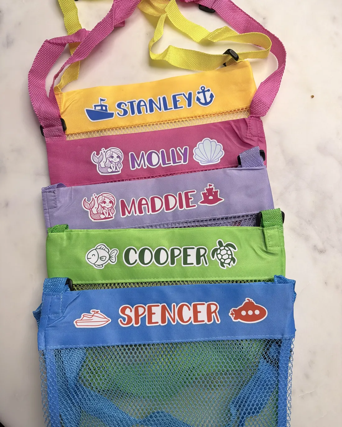 Mesh beach bags personalized for a group of kids