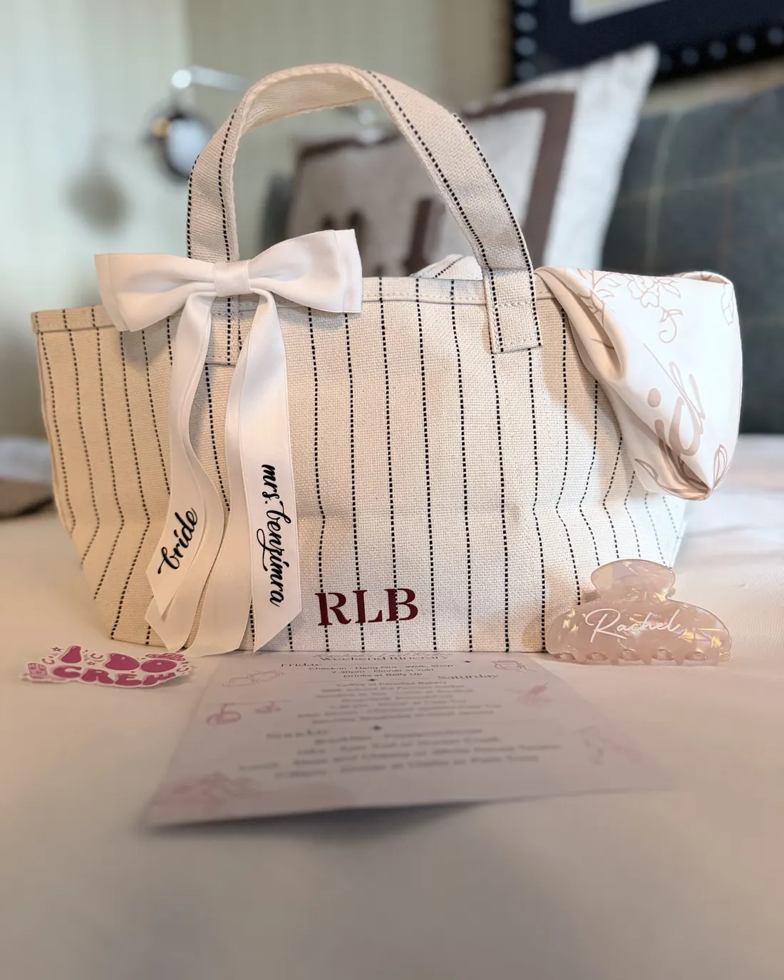 Pinstripe tote with monogram and a bow lettered for the bride