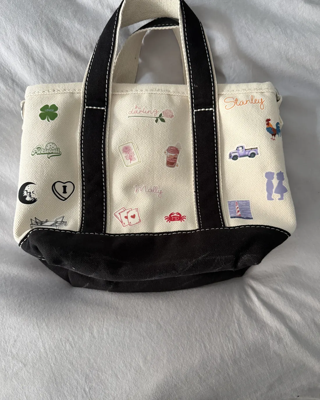 Black and cream mini tote embroidered with names and a mix of custom icons